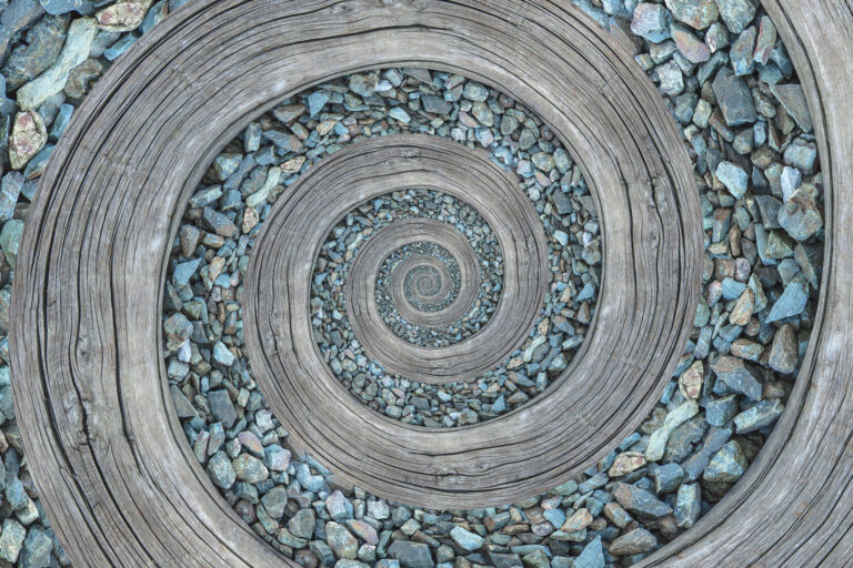 Spiral path of wood and turquoise gravel