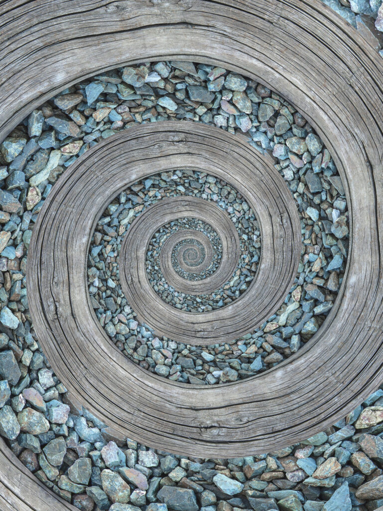 Spiral path of wood and turquoise gravel