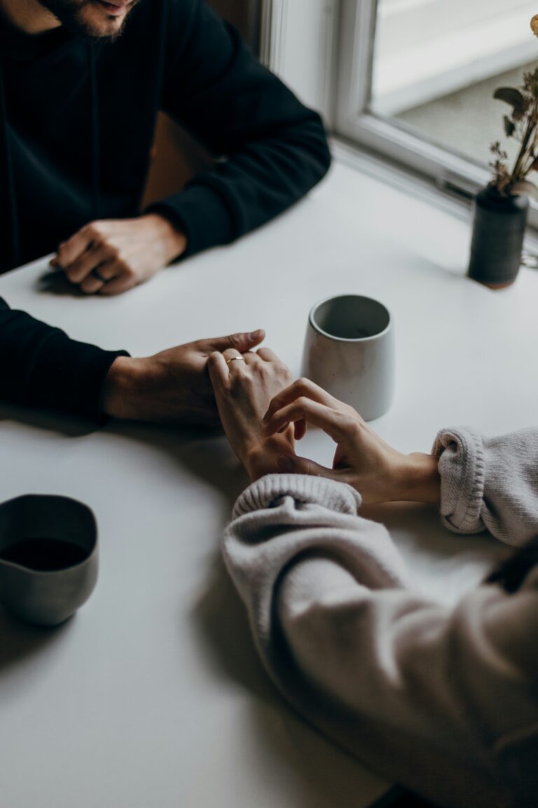 Couple sharing coffee and conversation at a table