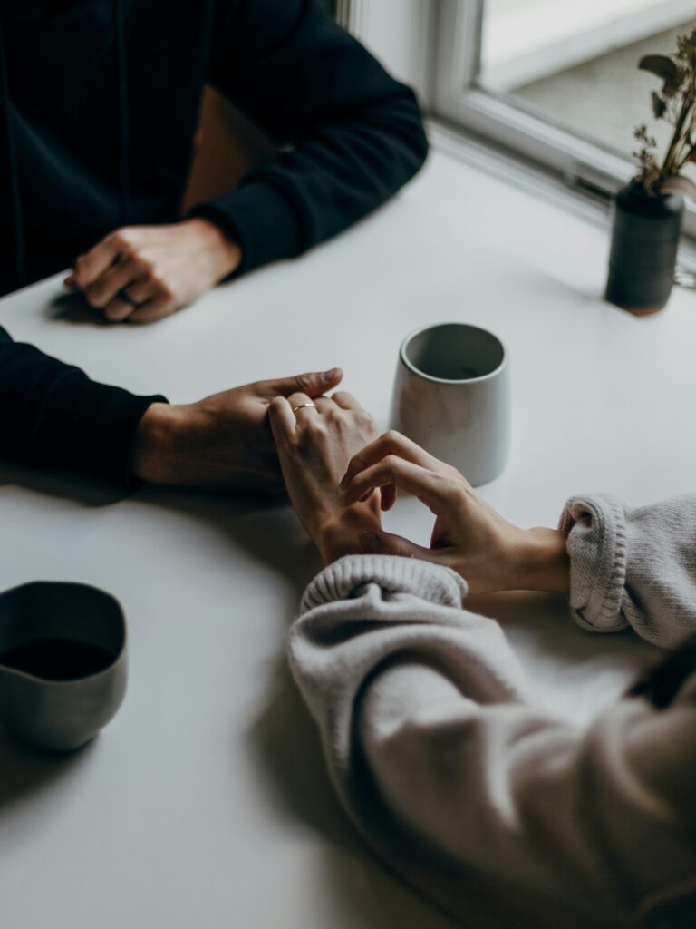 Couple sharing coffee and conversation at a table